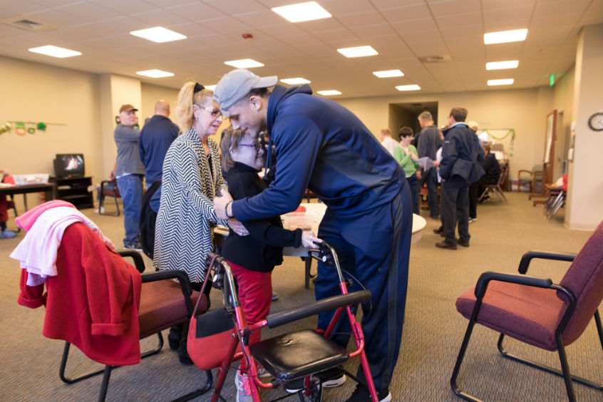 A mutual fan club between Cedric Jacobs-Jones ’19, a wing player, and Cynthia, a resident. A HopeTree staffer, Vera, assists.  