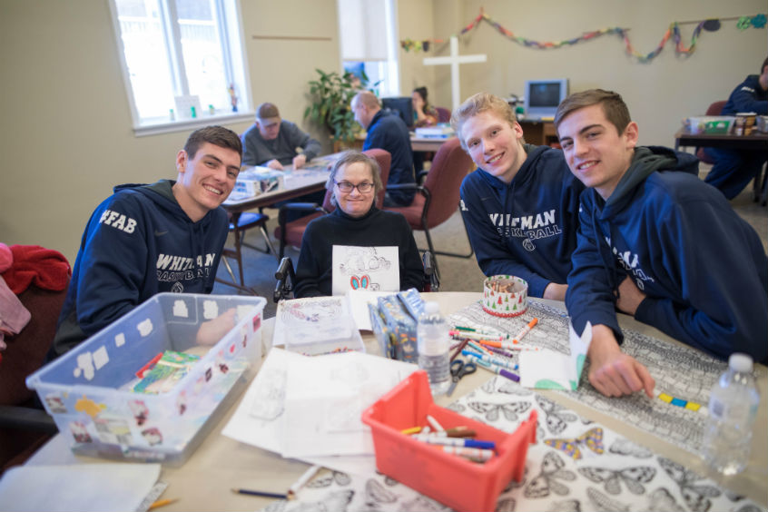 A mutual fan club between Cedric Jacobs-Jones ’19, a wing player, and Cynthia, a resident. A HopeTree staffer, Vera, assists.  
