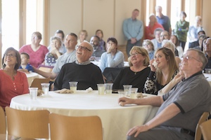 Cleveland, Sorenson (center right) and their daughter, Molly (with napkin), enjoy a video tribute to him by Tywen Kelly ’18, a film and media studies major.