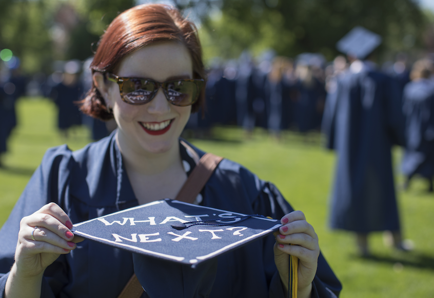 Holding cap that says "What's next?"