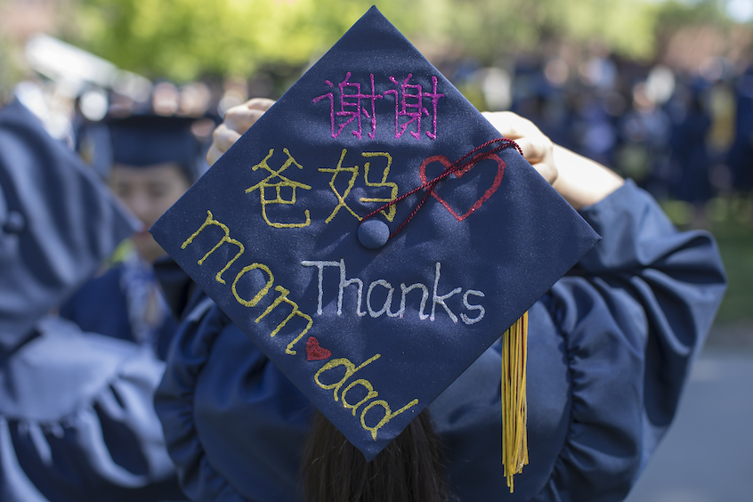 Wenjun Gao wearing cap that say "Thanks, mom and dad" in English and Chinese. 