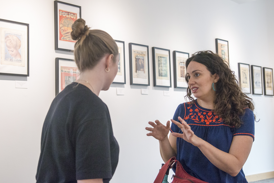 Jennine Capó Crucet (right) tours the Stevens Gallery, currently showcasing work by artist Paul Valadez, in Whitman's Reid Campus Center.