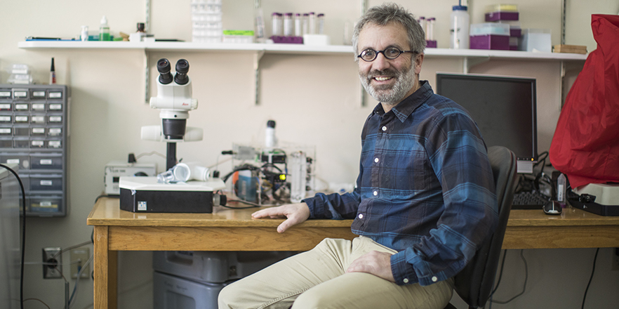 Juers sits next to a prototype of his patented invention, Watershed