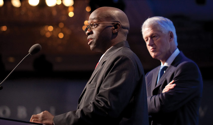 Ashifi Gogo speaks at the Dartmouth Innovation Program as former President Bill Clinton observes. Photo courtesy the Clinton Global Initiative.