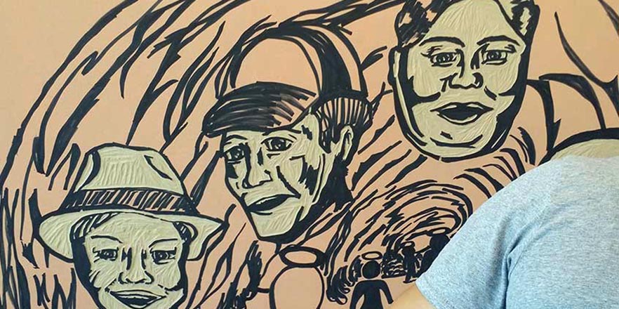 Student carves woodblock in preparation for Dio de los Muertos