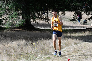 Carl Ye runs through a field.