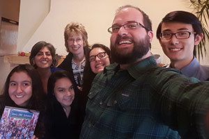 Kyle Martz stakes a selfie with a group of international students.