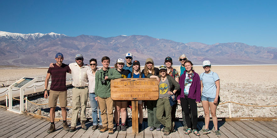 Lyman Persico and his students stand in the desert.