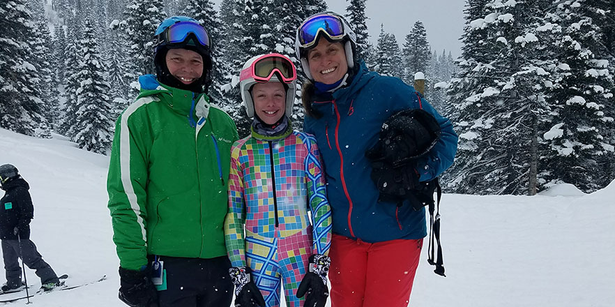 Chris Bromley, left, his daughter and his wife pose for a photo on a ski hill. 