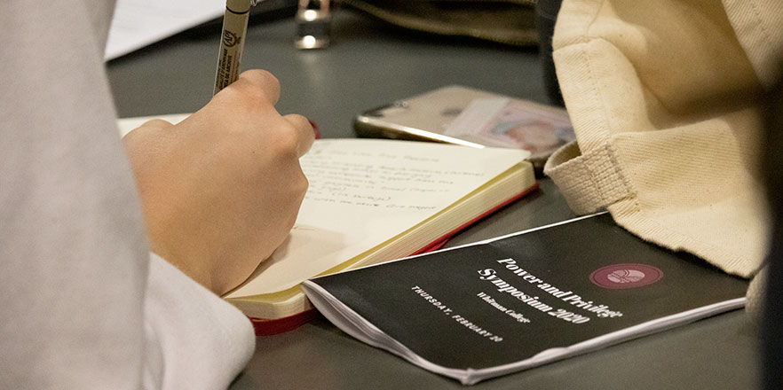 A student takes notes during a Power and Privilege session.