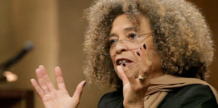 Angela Davis gestures during a speech.