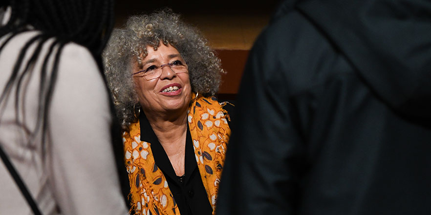 Angela Davis speaks with students during a book signing.