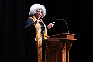 Angela Davis speaks at the podium.