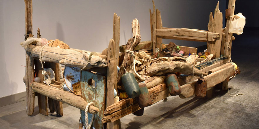 A piece from Tess Francavilla's senior thesis — mixed media wooden bed frame, sanded and artifically weathered, driftwood, rusted metal, trash gathered along the Columbia River.