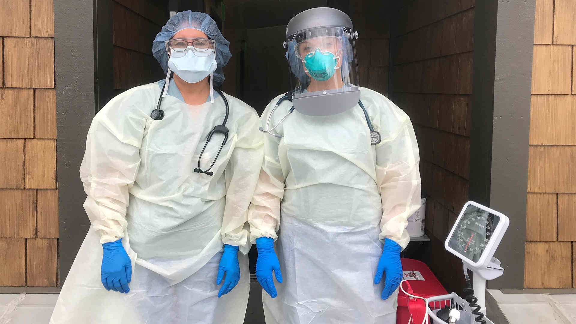 Two medical workers in full PPE gear