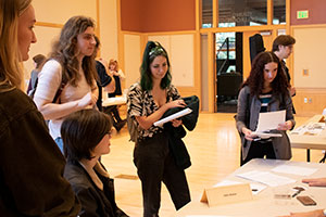 Students talk to an employer at a job fair.