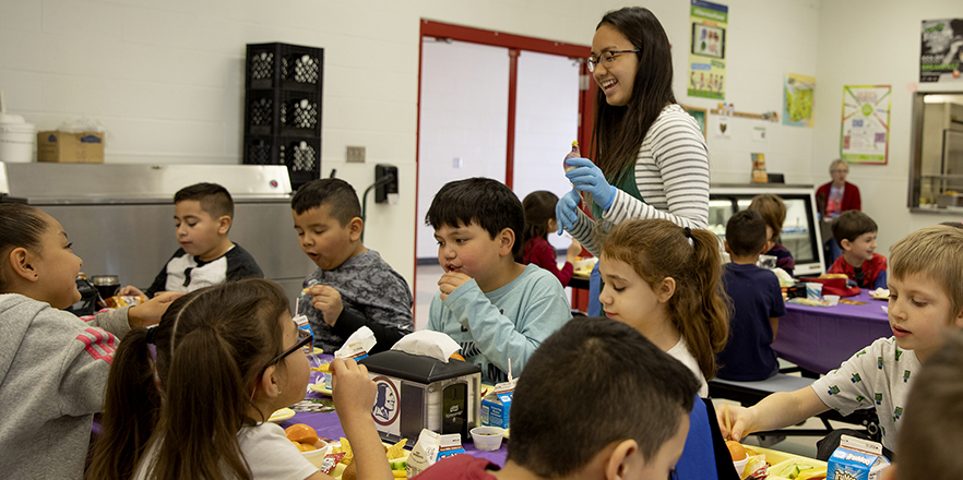 A photo of Jessica Luong working with children 