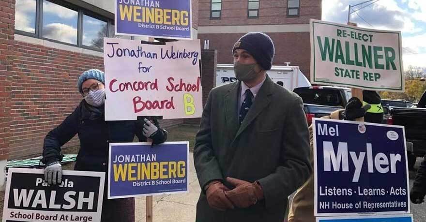 Whitman student in front of rally signs