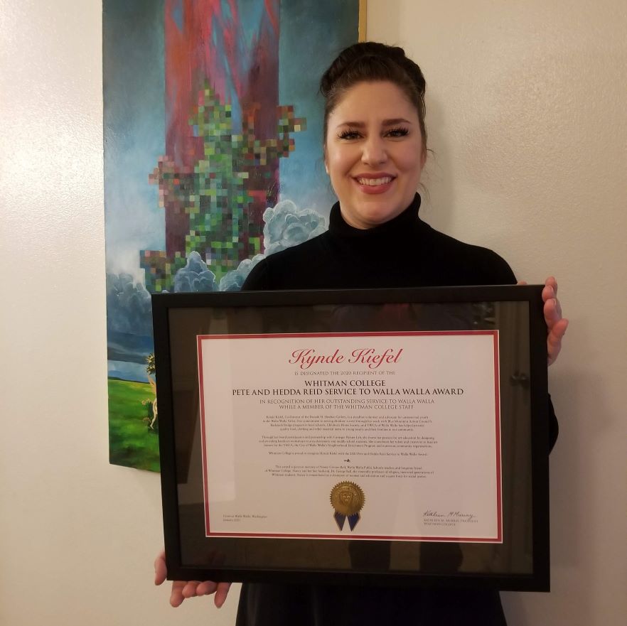 Kynde Kiefel smiles while holding her award