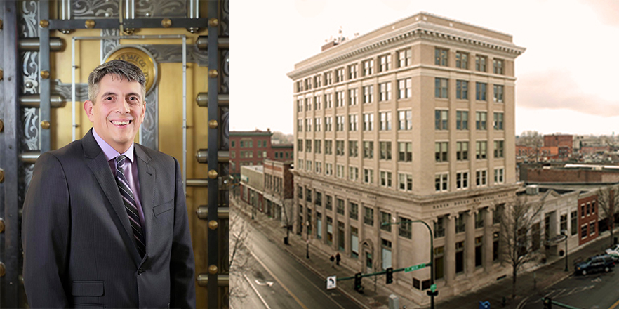 Rosendo Guizar ’94 Chief Credit Officer at Baker Boyer Bank, wearing a dark grey suit and standing in front of the brass door of a bank vault.