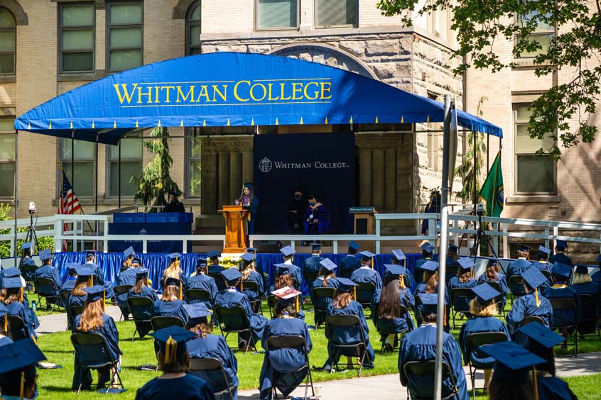 Graduates in front of commencement stage