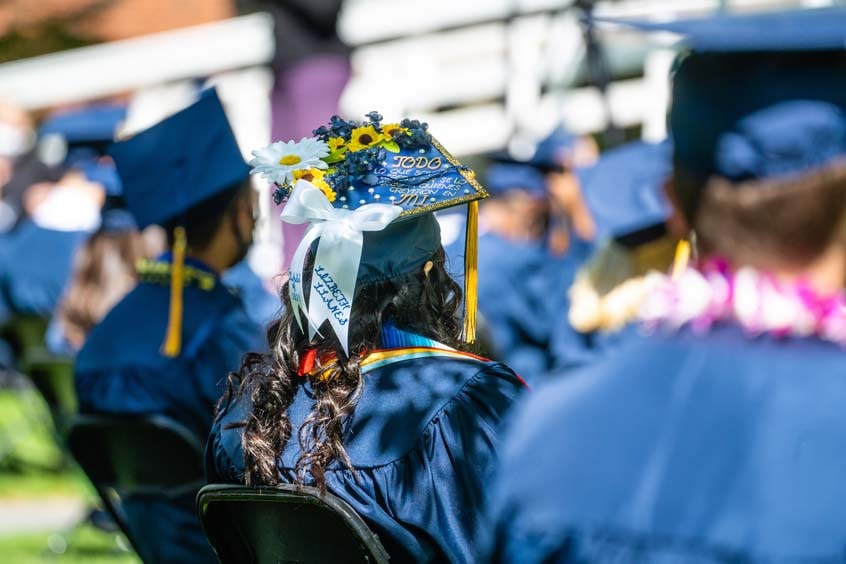 Graduate sitting with a view of the mortarboard top