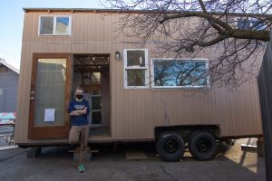 Preskenis stands outside the tiny house he built