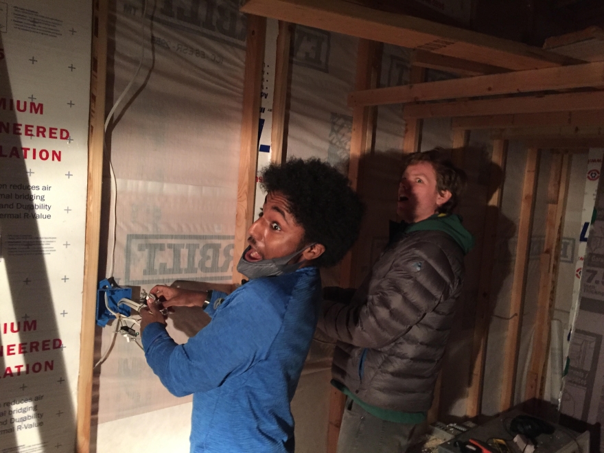 two Whitman students work on the interior construction of the tiny house