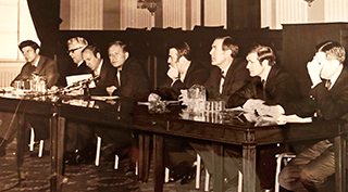 Ian MacGowan and fellow activists sit behind a table