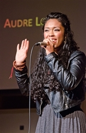 Aisha Fukushima speaks to a crowd.