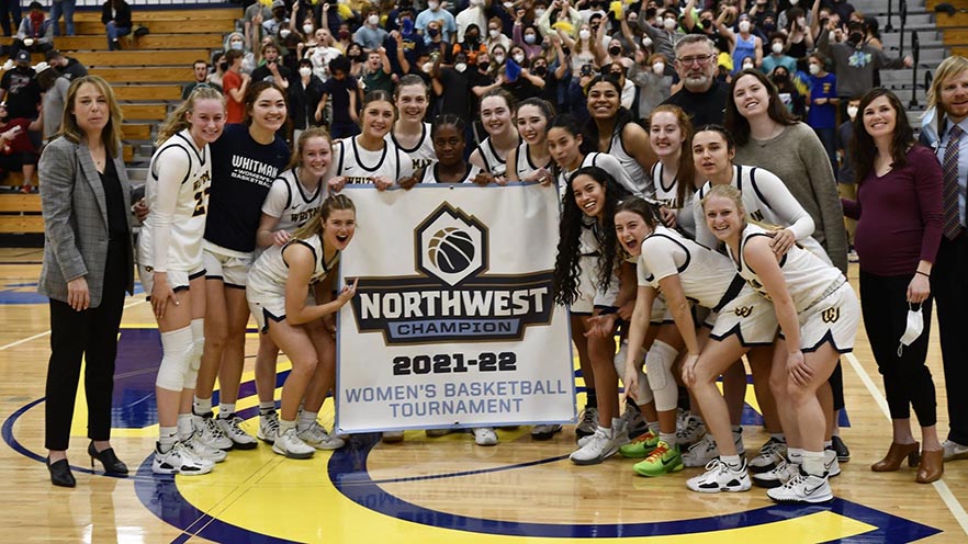 The Whitman College Women's Basketball Team celebrate winning the Northwest College Tournament.