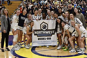 The Whitman College Women's Basketball Team celebrate winning the Northwest College Tournament.