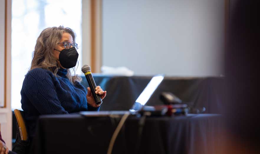 A community leader speaks into a microphone.
