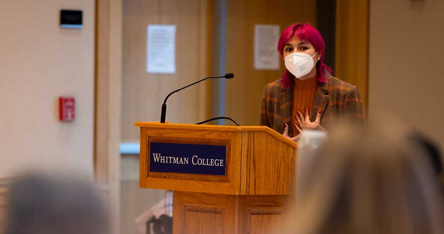 Tatiana Villegas speaks behind a podium.