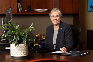 Sarah Bolton sitting at her desk.