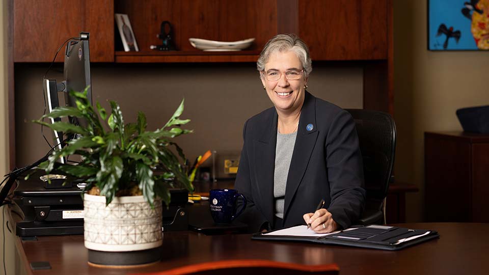 Sarah Bolton sitting at her desk.