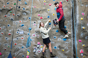 Students climbing a wall