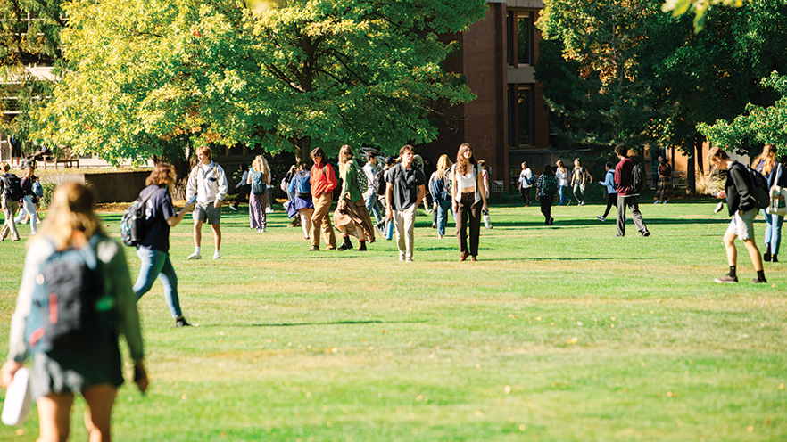 Students walking across Ankeny Field on Whitman College campus 