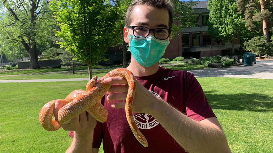 Willem Rasmussen ’15 holding Candy the corn snake.