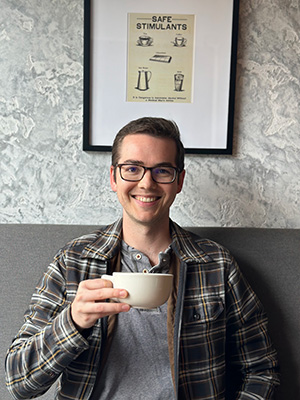 Willem Rasmussen holding a cup of coffee.