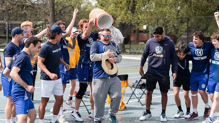 2024-25 Whitman Men's Tennis Team dumping water on Coach Jeff Northam