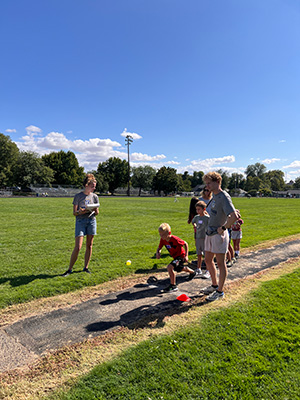 Whitman College Cross Country team members helping out at an elementary school at the Kids All-City Track Meet